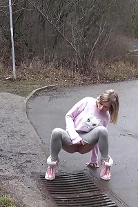Light-haired Beauty Claudia Pisses Down A Drain Outside